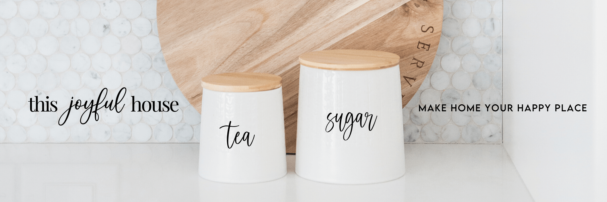 2 containers sit on a bright white countertop with a large cutting board behind. The text reads This Joyful House, Make Home Your Happy Place